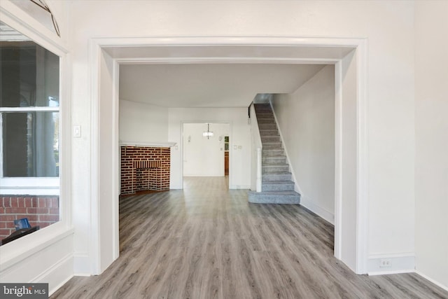 unfurnished living room featuring light hardwood / wood-style floors and a fireplace