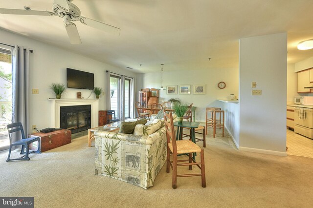 living room with light carpet and ceiling fan