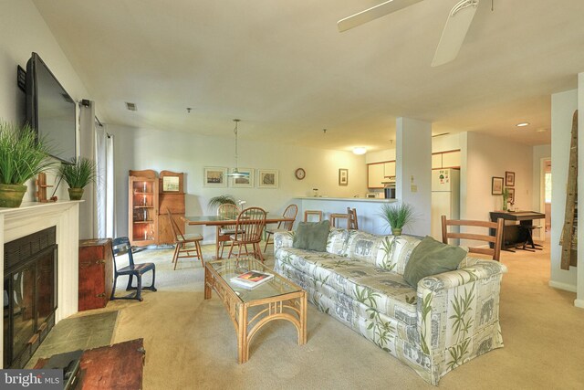 carpeted living room featuring ceiling fan