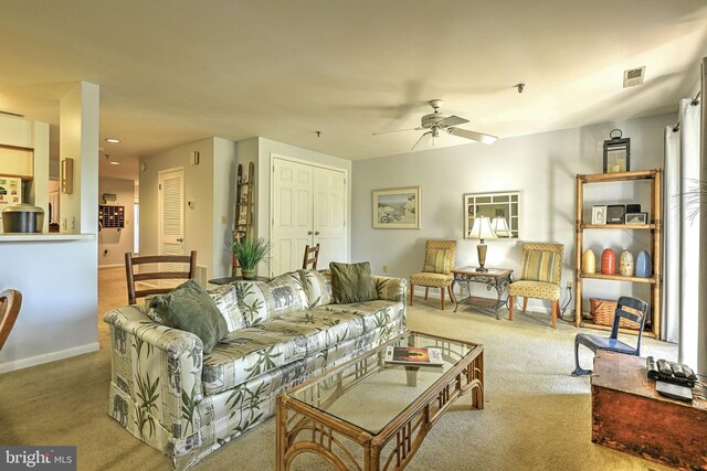 living room featuring light colored carpet and ceiling fan