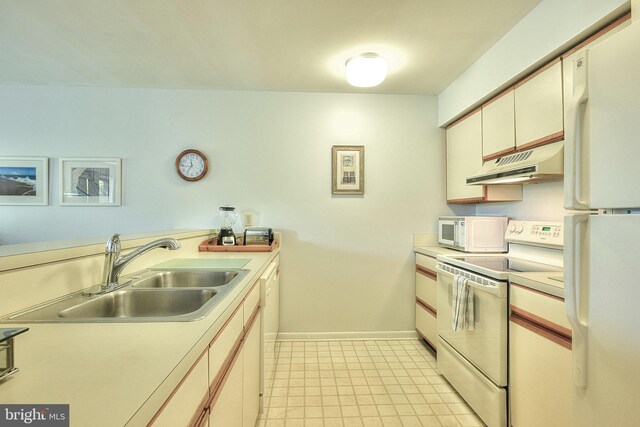 kitchen with white appliances, white cabinetry, and sink