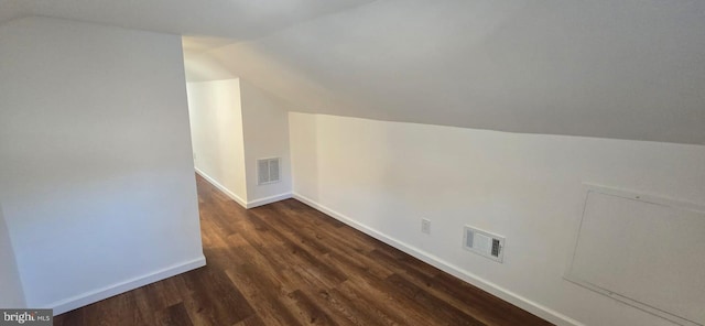 bonus room with lofted ceiling and dark wood-type flooring