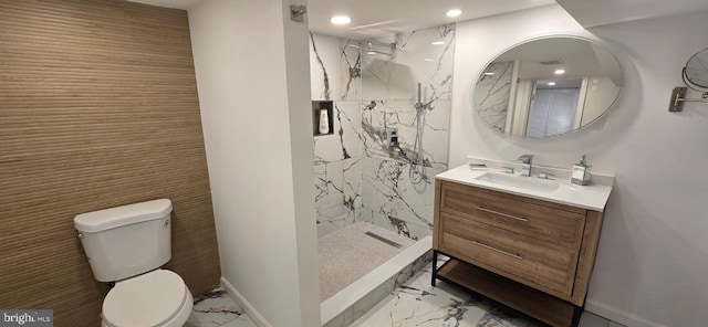 bathroom with vanity, toilet, walk in shower, and tile walls