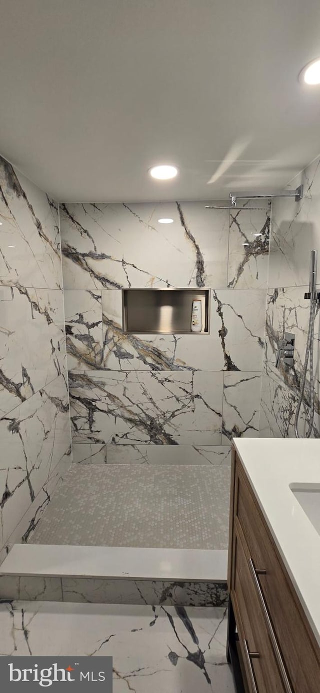 bathroom with vanity and a shower