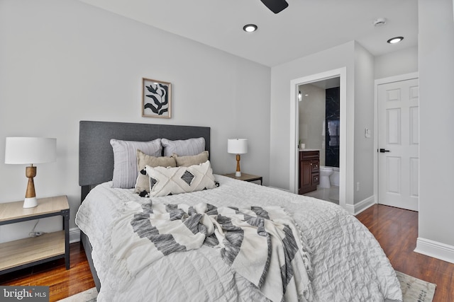 bedroom with dark wood-type flooring and ensuite bath