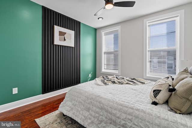 bedroom with hardwood / wood-style flooring and ceiling fan