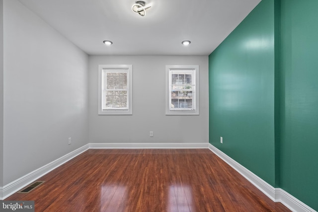 spare room featuring dark hardwood / wood-style flooring