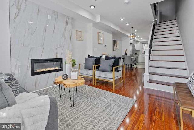 living room with a premium fireplace and hardwood / wood-style floors