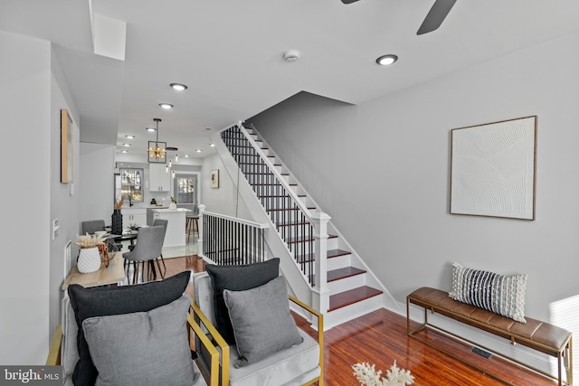 staircase featuring a chandelier and hardwood / wood-style floors