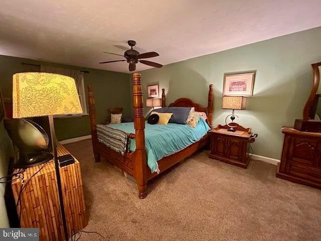 bedroom with light colored carpet and ceiling fan