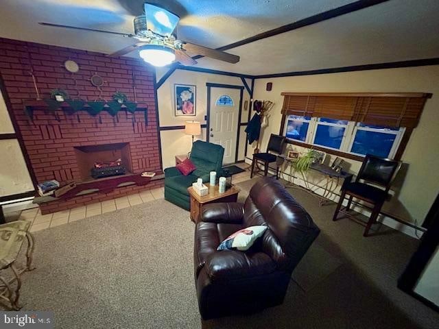 living room featuring crown molding, carpet flooring, a fireplace, and ceiling fan