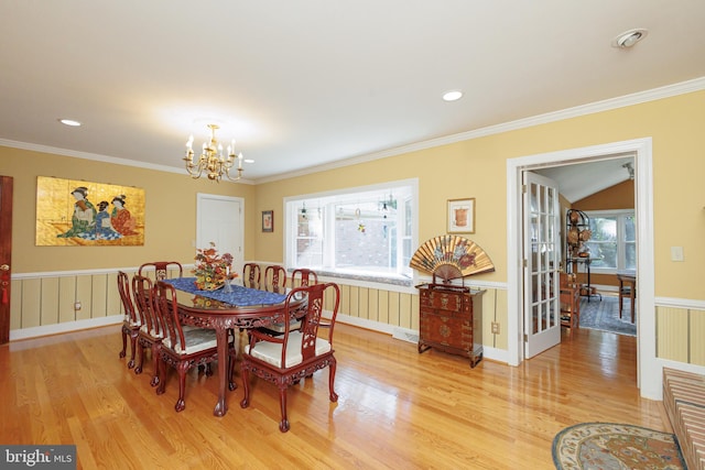 dining area featuring crown molding, wood-type flooring, and a healthy amount of sunlight