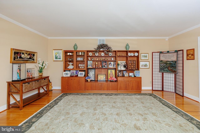 miscellaneous room featuring ornamental molding and hardwood / wood-style floors