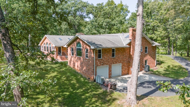 exterior space featuring a garage and a front lawn