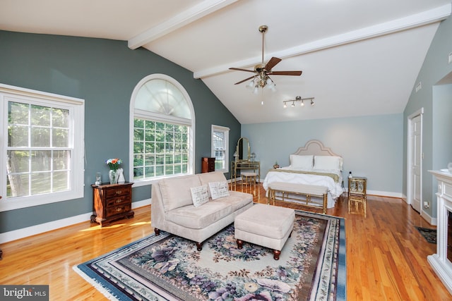 bedroom with light hardwood / wood-style floors, lofted ceiling with beams, and ceiling fan