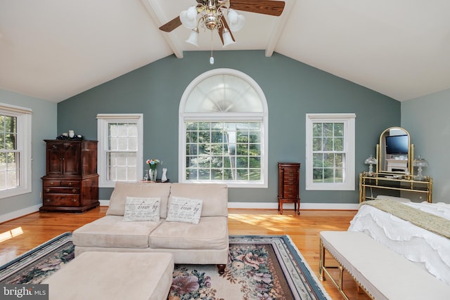 living room featuring light hardwood / wood-style flooring, lofted ceiling with beams, and ceiling fan