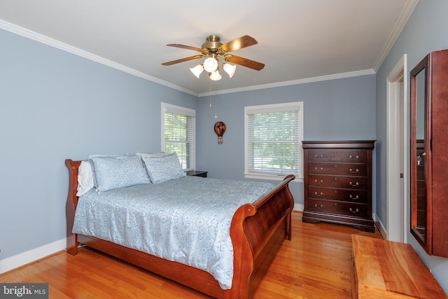 bedroom with crown molding, light hardwood / wood-style floors, and ceiling fan