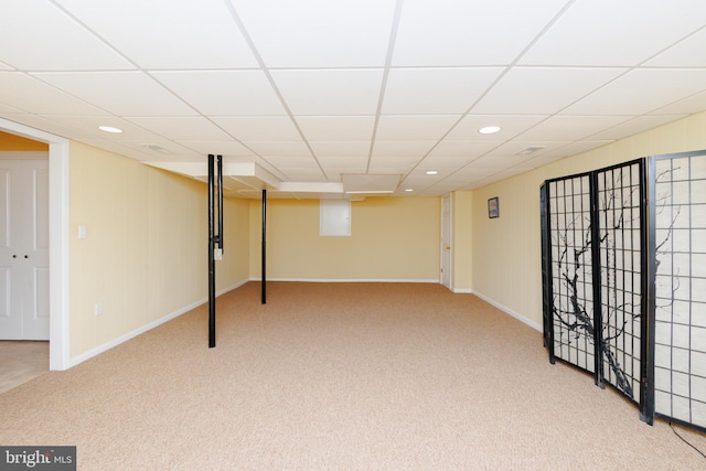 basement featuring carpet and a drop ceiling