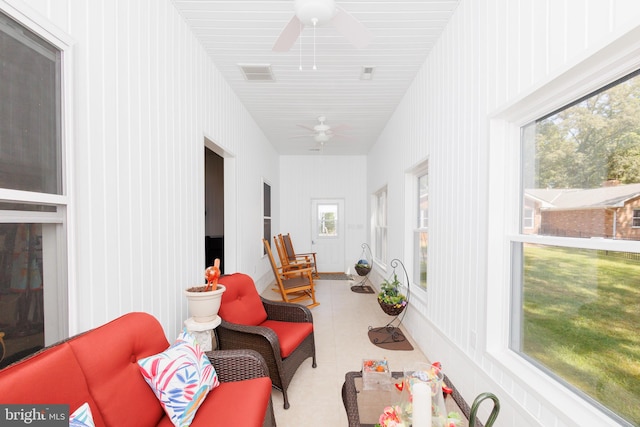 sunroom featuring ceiling fan