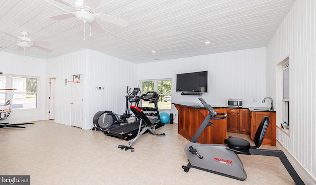 workout area with ceiling fan, sink, and plenty of natural light