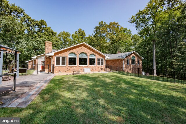 rear view of house featuring a lawn