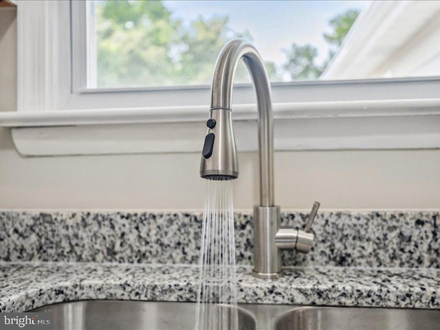 details with light stone countertops and sink