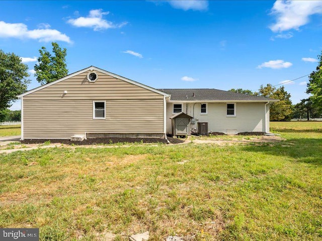 rear view of house with a yard