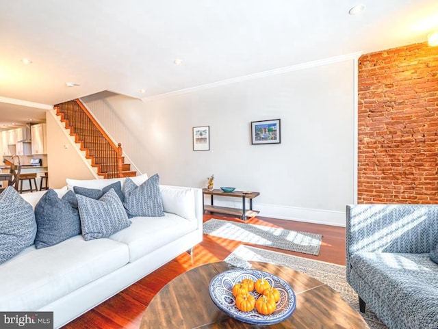 living room featuring ornamental molding and wood-type flooring