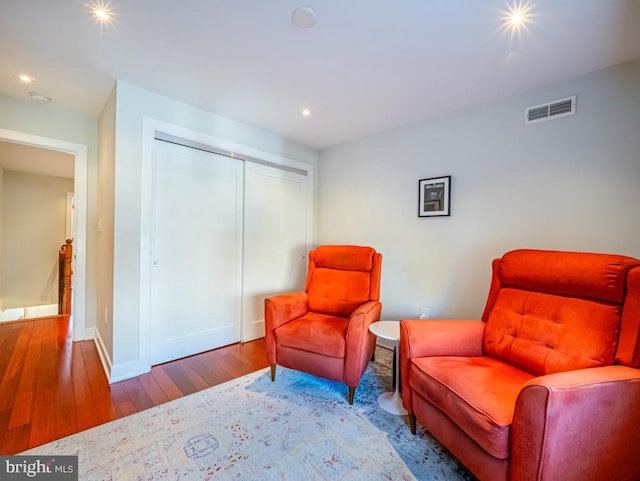 living area with hardwood / wood-style flooring