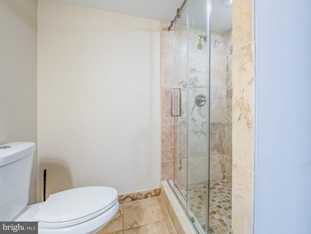 bathroom featuring toilet, walk in shower, and tile patterned floors