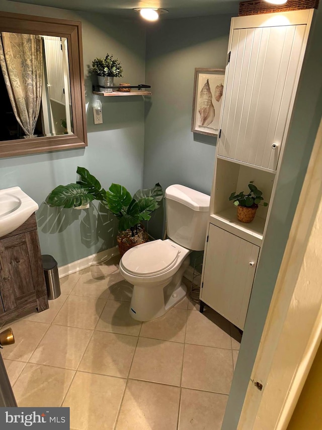 bathroom featuring vanity, toilet, and tile patterned flooring