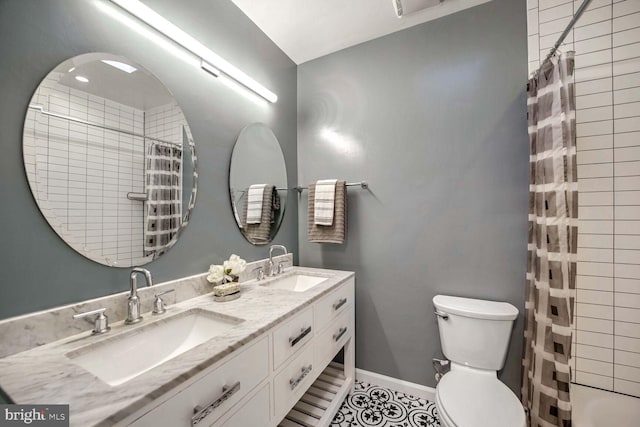 bathroom with toilet, a shower with curtain, vanity, and tile patterned floors