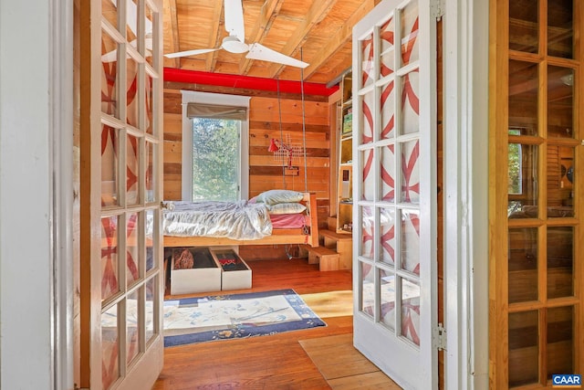 bedroom featuring hardwood / wood-style floors, wooden walls, and wooden ceiling