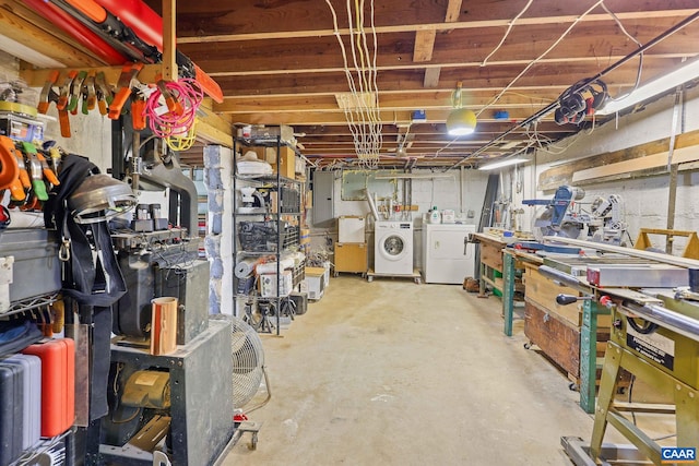 basement featuring electric panel and independent washer and dryer