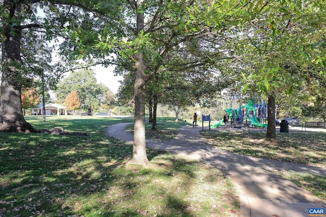 view of property's community with a yard and a playground