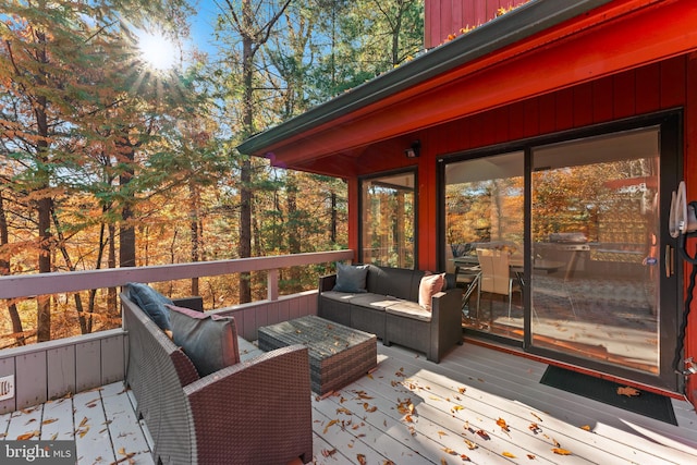 wooden deck with an outdoor living space