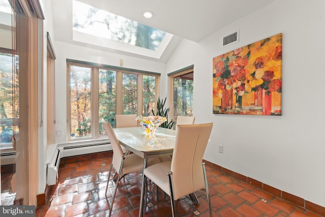 dining area featuring vaulted ceiling