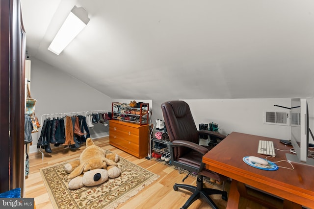 office featuring hardwood / wood-style flooring and vaulted ceiling