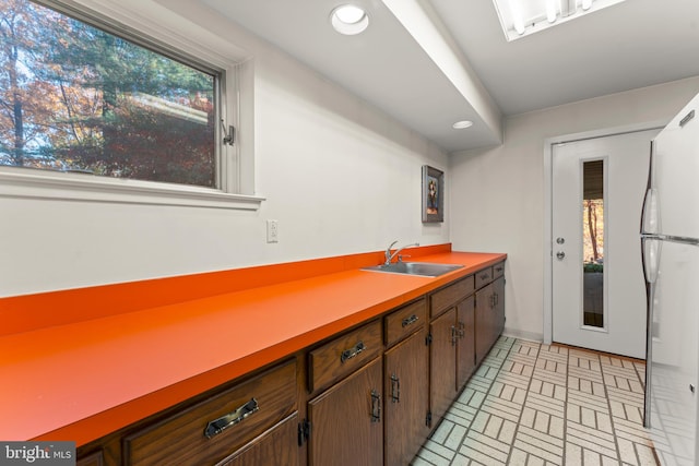 kitchen featuring sink and white refrigerator