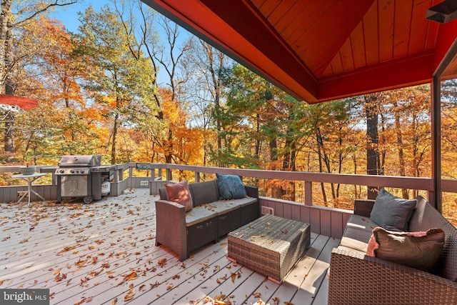 deck with an outdoor hangout area and a grill