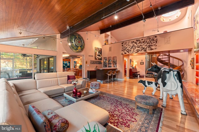 living room with wood ceiling, hardwood / wood-style flooring, beamed ceiling, and high vaulted ceiling