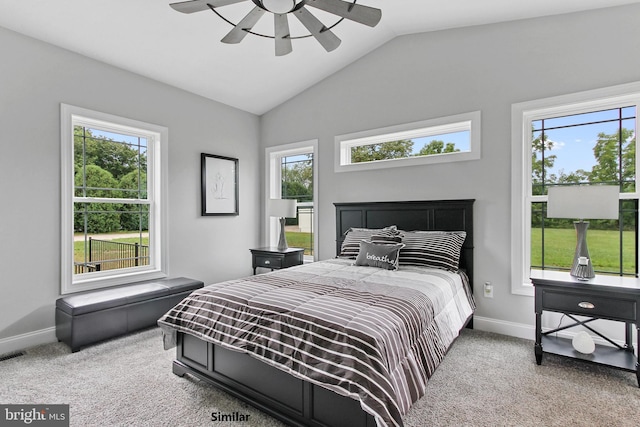 carpeted bedroom featuring multiple windows, lofted ceiling, and ceiling fan