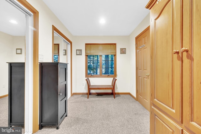 interior space featuring recessed lighting, light colored carpet, and baseboards