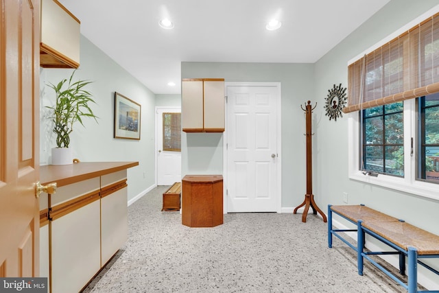 interior space with light speckled floor, recessed lighting, and baseboards