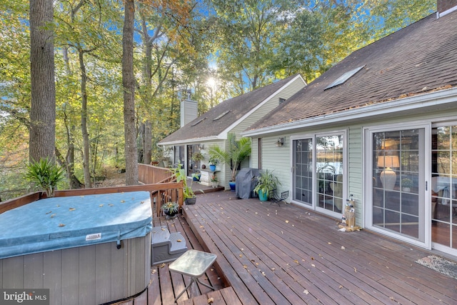 deck featuring area for grilling and a hot tub