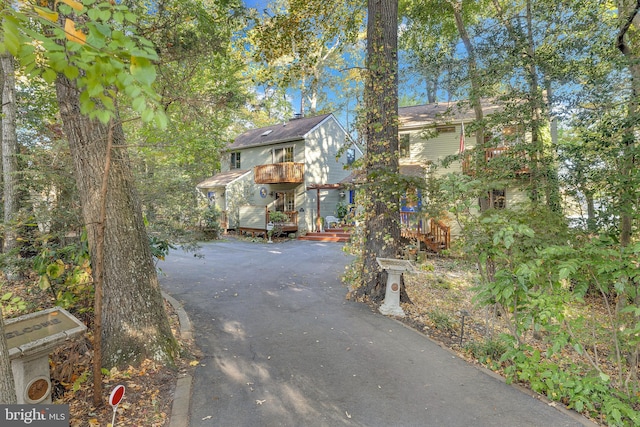 view of front of home with a balcony and driveway