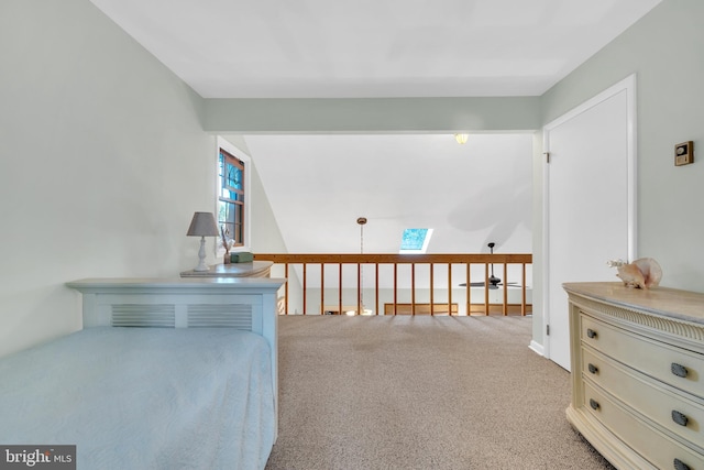 living area featuring a skylight and carpet flooring