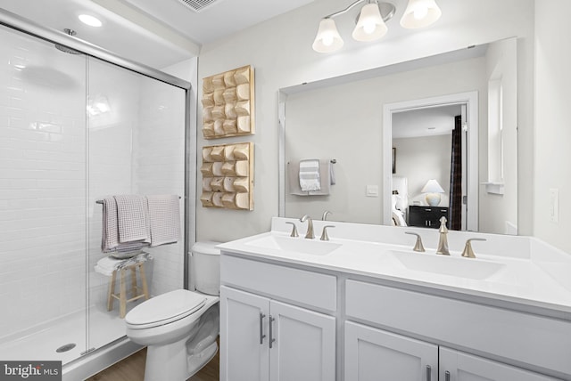 bathroom with toilet, a shower with shower door, wood-type flooring, and vanity