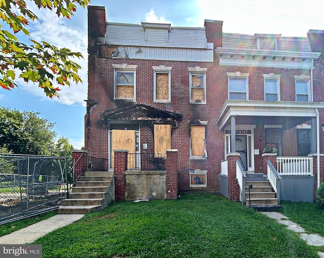 view of property featuring a front yard and a porch