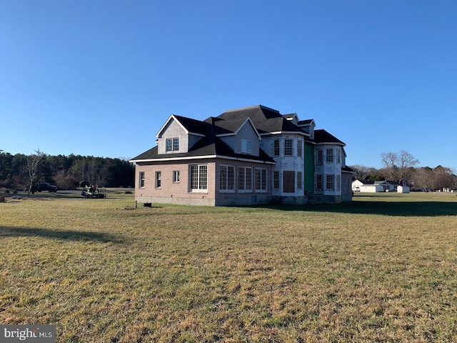 rear view of property featuring a yard